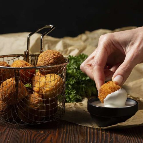 Close Up Hand Holding Food Croquette
